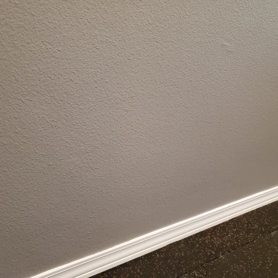 Wall and baseboard after cleaning, free of scuffs
