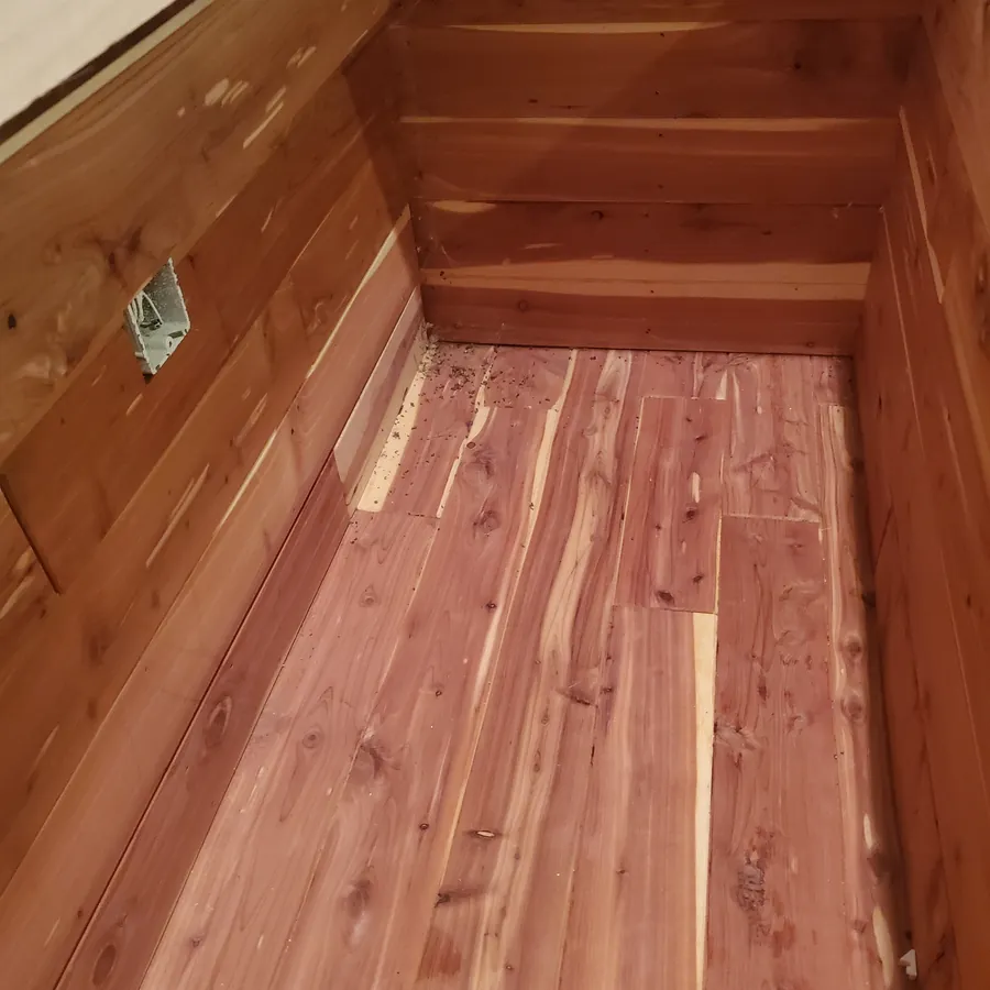 The same cedar chest before cleaning, with dust in the corners