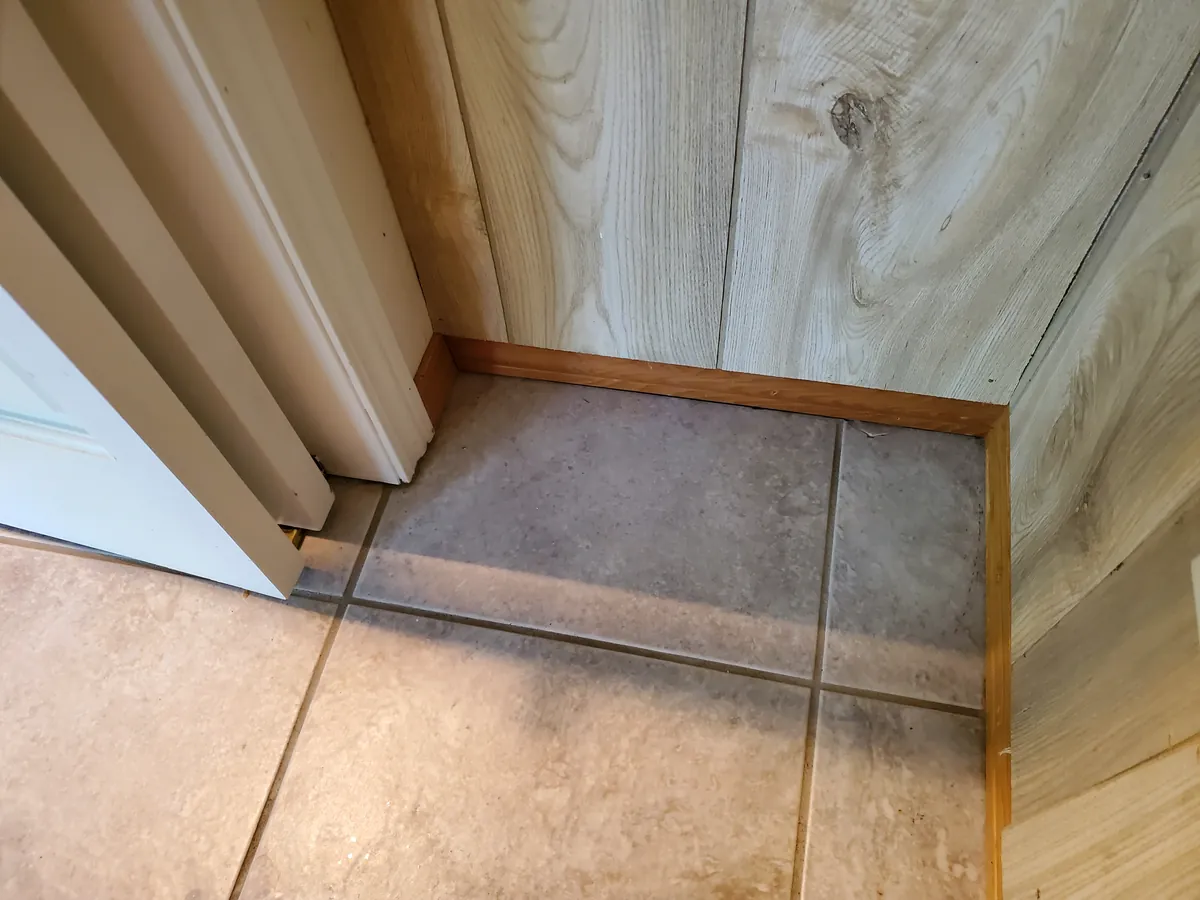 Closet floor after a clean, clear along the baseboard and door