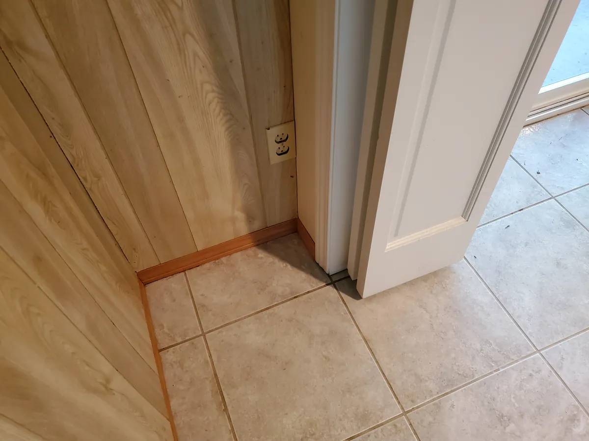 Closet floor and baseboard after cleaning, clear of debris