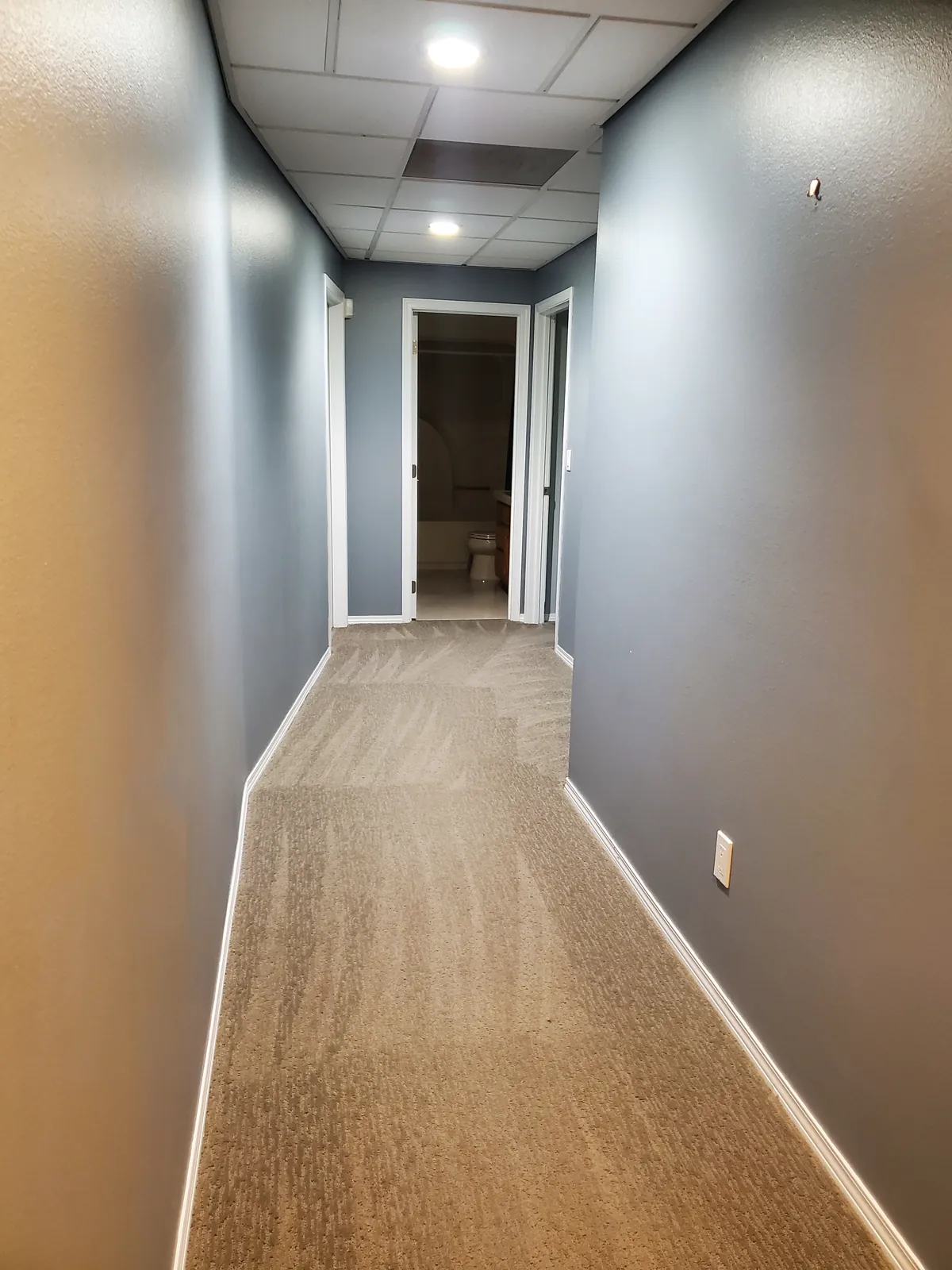 Long hallway after a clean, floor clear from end to end