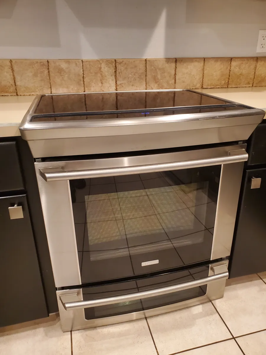 A polished stainless steel range after cleaning