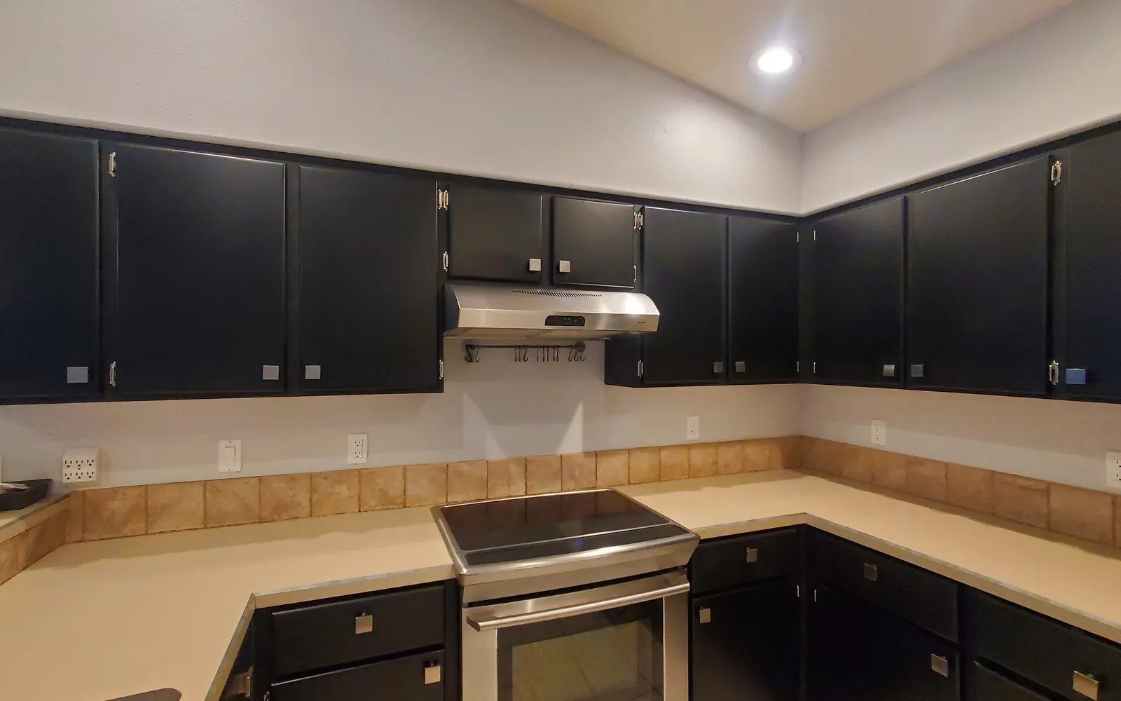 A kitchen after a Wholeheart Home clean: clear counters, polished stainless appliances, and spotless cabinet fronts
