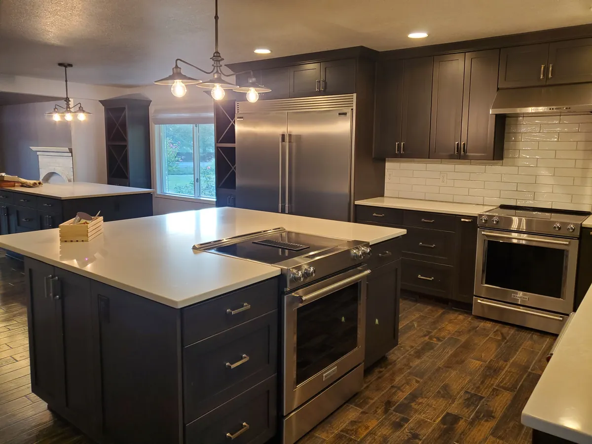 Kitchen after a clean, with a quartz island, stainless appliances, and wood-look floors