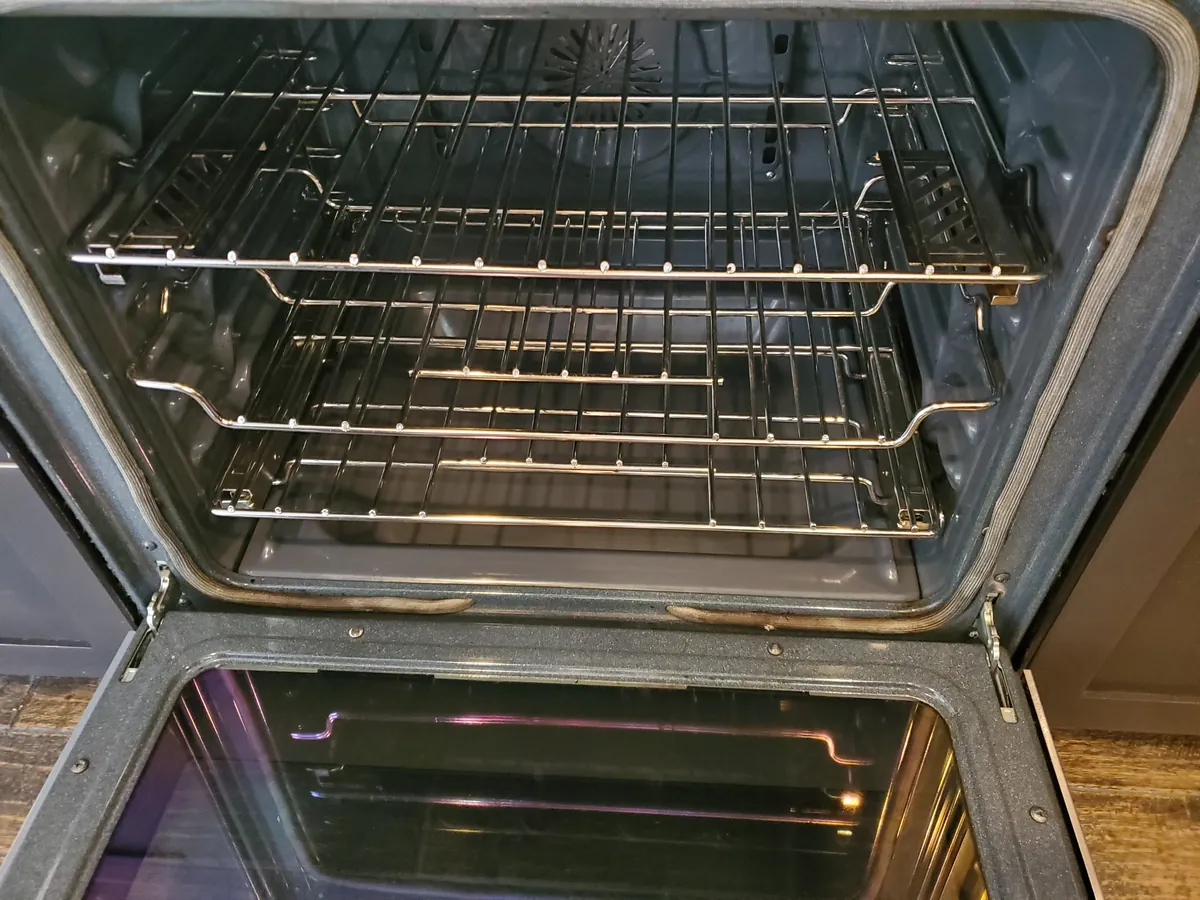 Oven interior and racks after cleaning, gleaming and grease-free