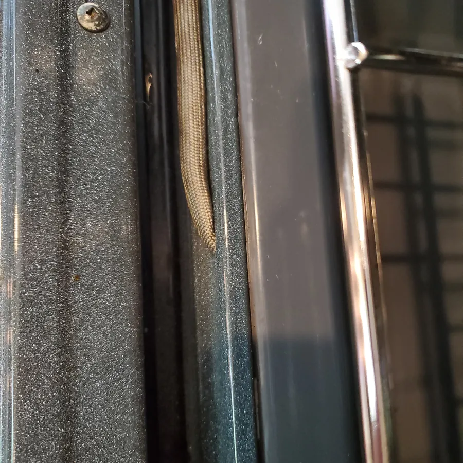 Oven door edge after cleaning, free of crumbs and grease